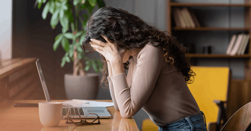 woman feeling overwhelmed working under pressure