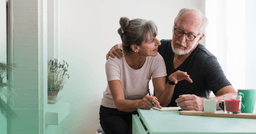 an older couple reviewing their insurance benefits together