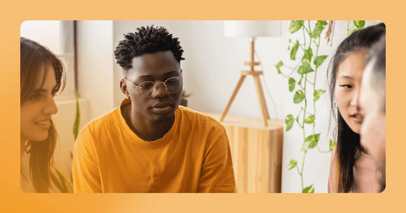 young man feeling overwhelmed by conversations going on around him