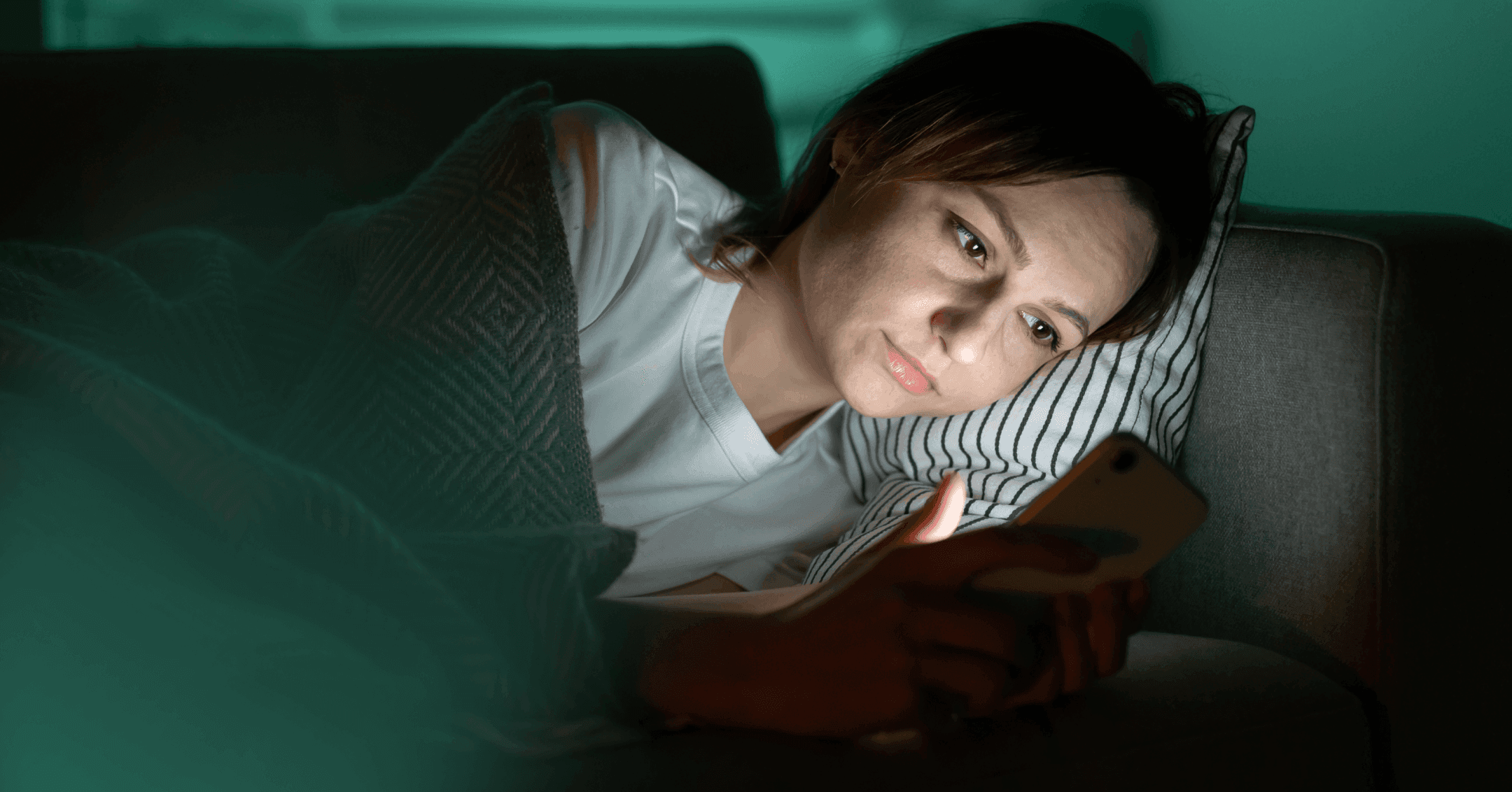 woman doomscrolling at night