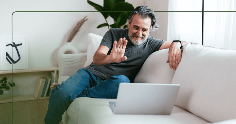 man with anxiety engaging in online therapy session on his couch at home