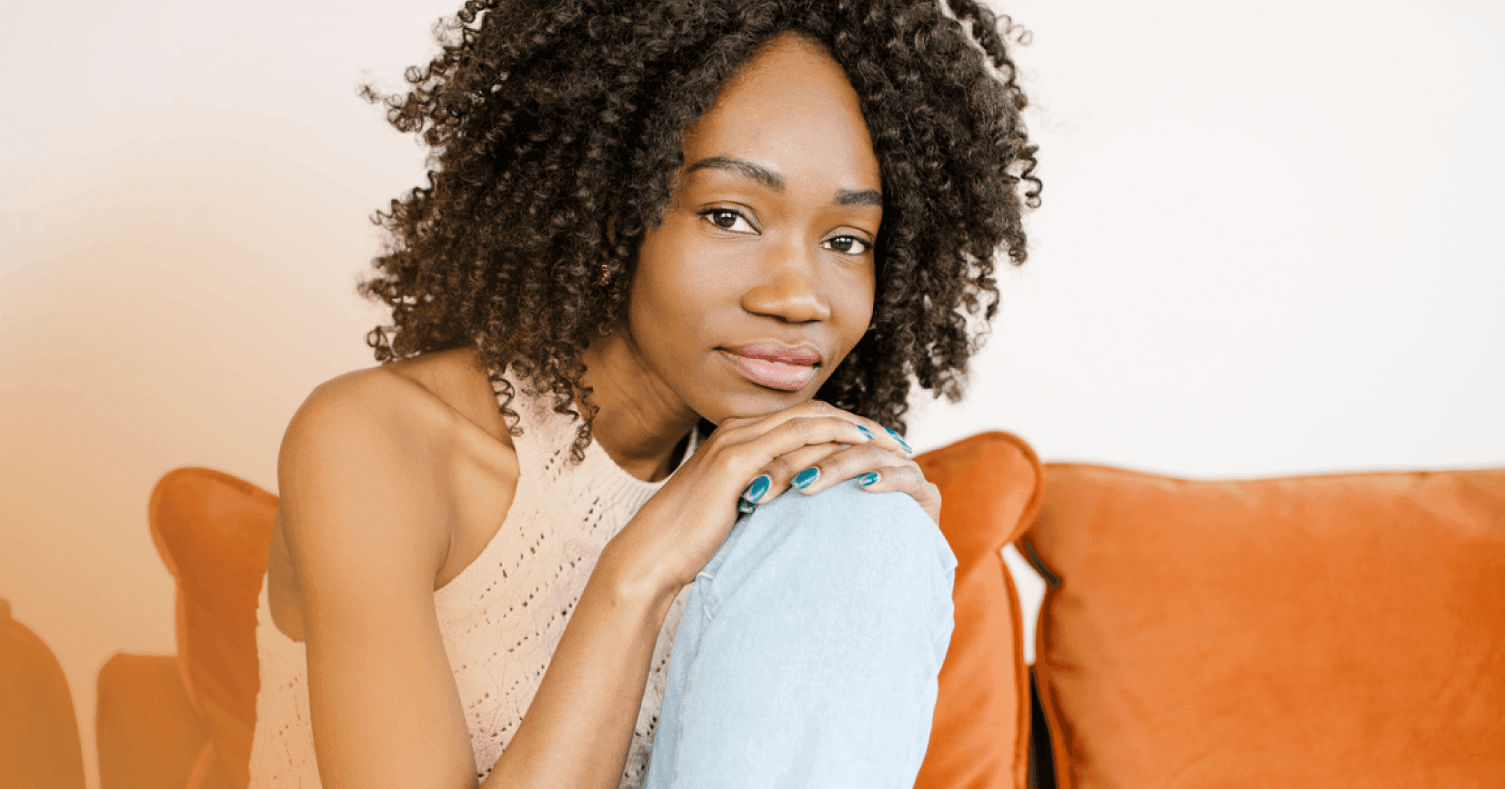 woman with depression sits on orange couch