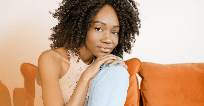 woman with depression sits on orange couch