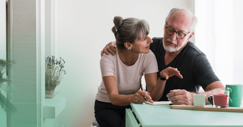 an older couple reviewing their insurance benefits together