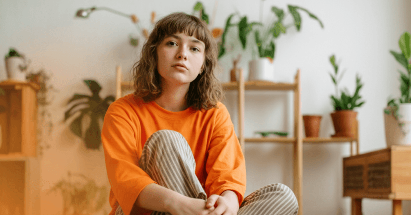 teenage girl with abandonment trauma sits on the floor