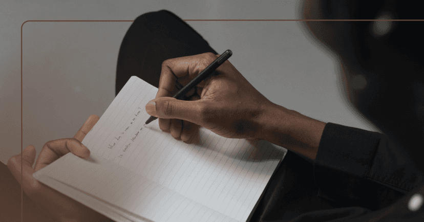 man writing out meaningful personal goals for the new year