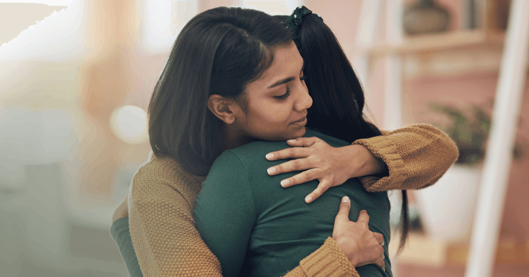 two women hugging after having an open conversation about self-harm