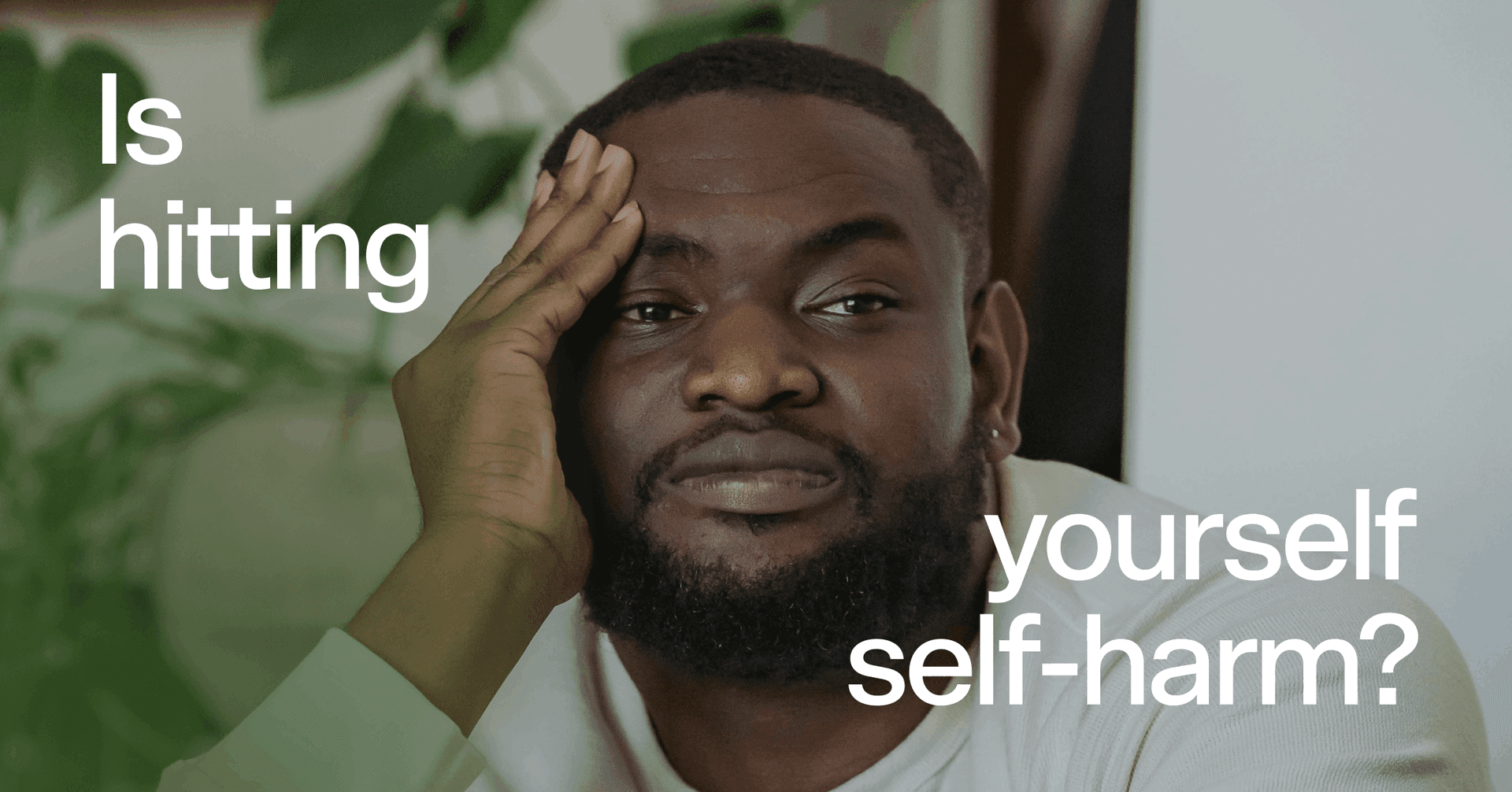 man trying to distract himself with text 'Is hitting yourself self-harm?'
