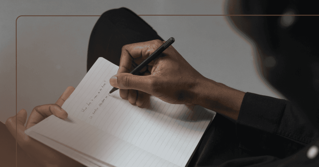 man writing out meaningful personal goals for the new year