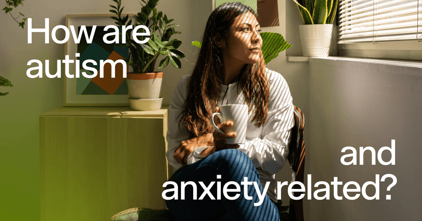 Woman is sitting in a chair with her legs crossed holding a white mug in her right hand looking out the window on her left. Her facial expression is intrigued. She is wearing a white long sleeve shirt with dark blue jeans. In the background are plants and a painting against a white wall. On top of the image in white text it reads How are autism and anxiety related?