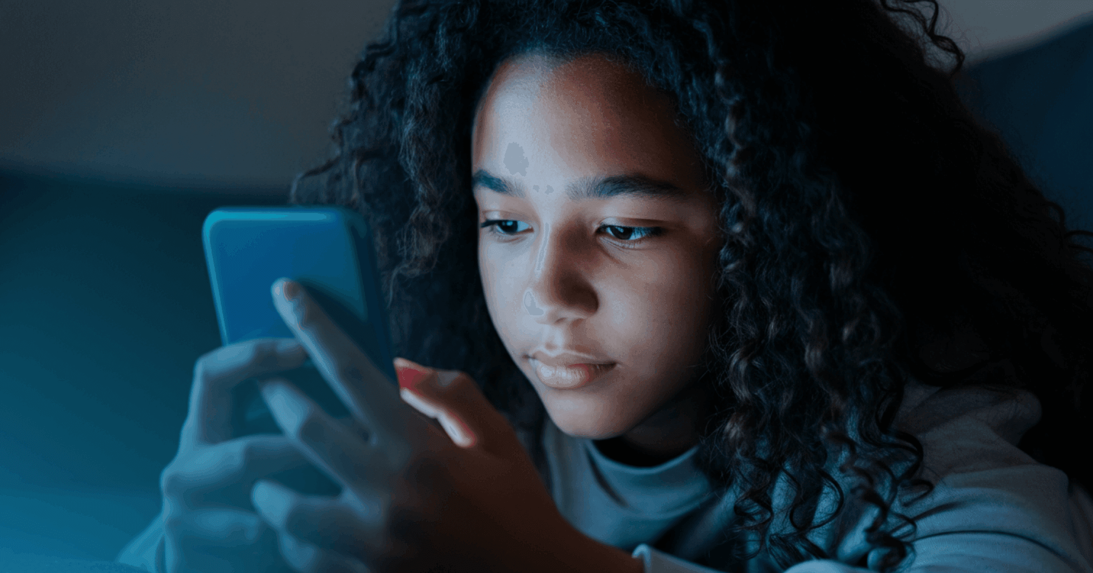 teen girl scrolling social media instead of sleeping